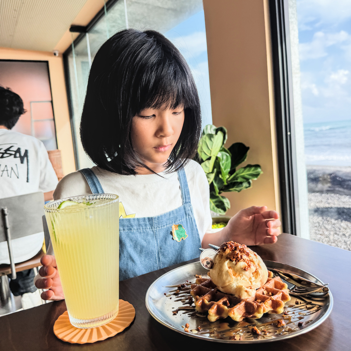 山男咖啡枋山店海景咖啡與甜點 山男咖啡枋山店窗外藍天與海洋作為背景,桌上擺放咖啡與甜點展現度假旅行氛圍